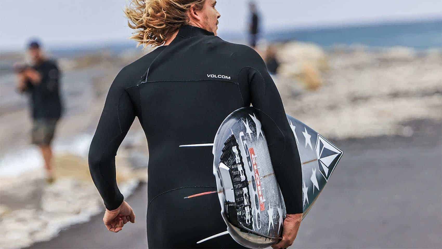 Volcom surfing dude with short board